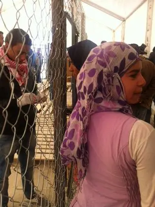 Women refugees from Syria queue to register on arrival at the Zaatari camp in Jordan (8423857990)