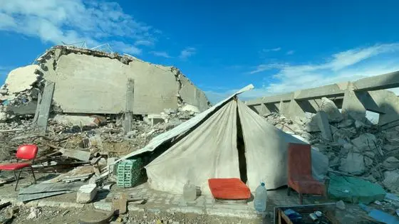 A tent set up by the homeowner among the rubble of his house after an Israeli airstrike in Gaza war